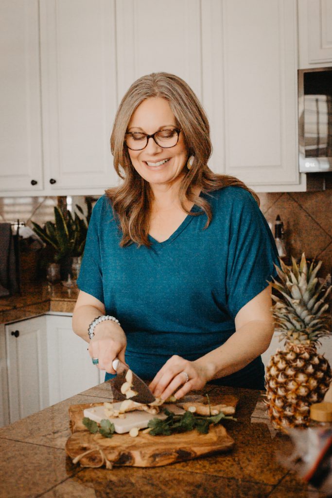 Jennifer McLeland in Kitchen cutting food